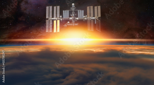 Fototapeta Naklejka Na Ścianę i Meble -  Planet Earth with a spectacular sunset with ISS 