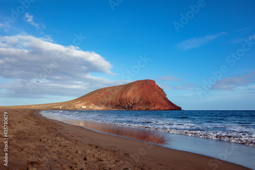 Scenic views of Montana Roja from the beach Playa Tejita, Special Natural Reserve and protected volcanic area in Granadilla de Abona, home to unique flora and fauna in Tenerife, Canary Islands, Spain photo
