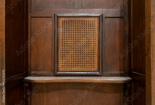 Wooden confessional from parishioner point of view photo