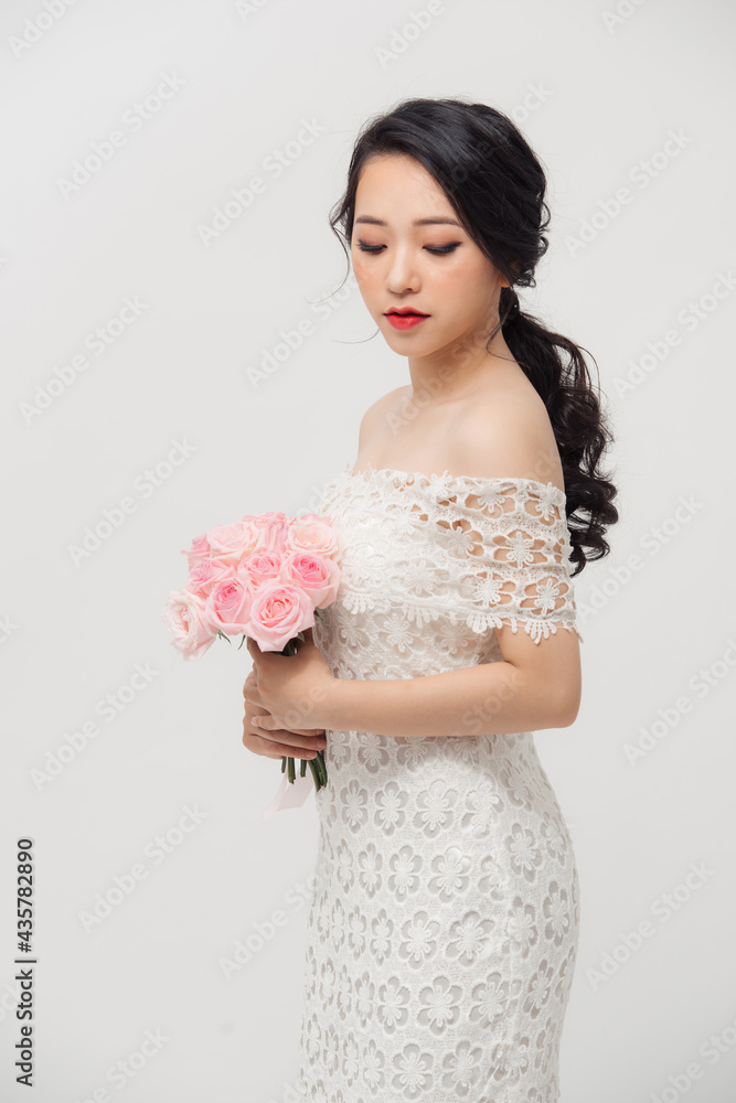 Fashion portrait of elegant woman with rose flower bouquet over white background. Fashion portrait of elegant woman with rose flower bouquet over white background.