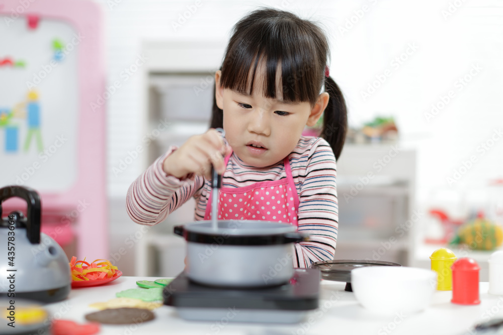 young girl pretend play food preparing at home young girl pretend play food preparing at home