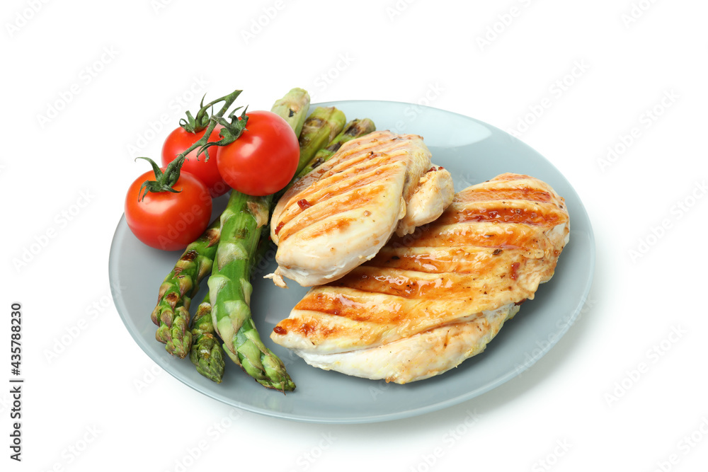 Plate with grilled chicken meat, asparagus and tomato isolated on white background