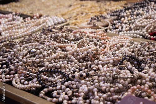 Bracelets and necklaces made from Ohrid pearls are sold in the market. Lots of feminine jewelry, background