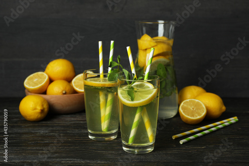 Glasses with fresh lemonade on wooden table