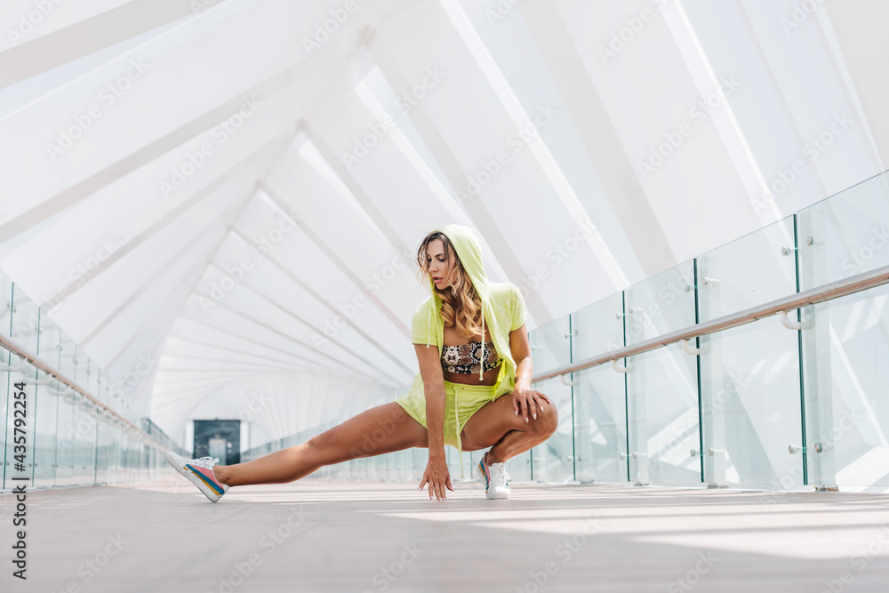 A young woman in sportswear performs exercises during a morning workout. Sports, fitness, healthy lifestyle
