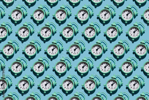 Table clock pattern in modern style with hard shadows, flat lay. Budtbook on a blue background in the form of a pattern. Irregular pattern. 