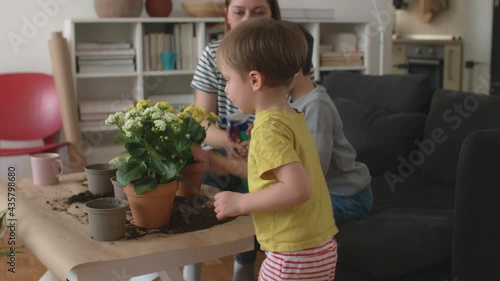 mother and children gardening houseplan at home photo