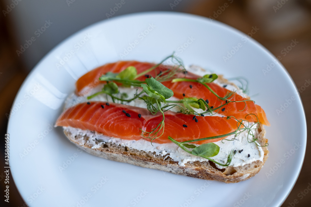 open sandwich with cereal bread and salmon, close up, selective focus