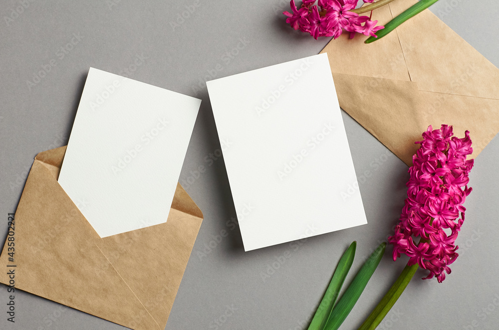Invitation card mockup, front and back sides with envelope and spring hyacinth flowers on grey Invitation card mockup, front and back sides with envelope and spring hyacinth flowers on grey