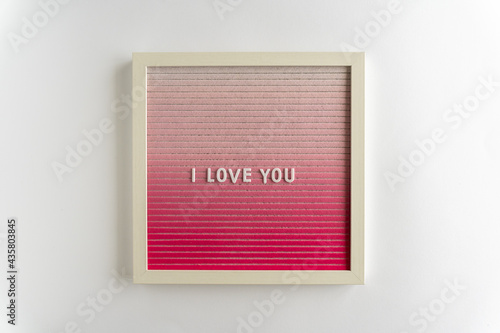 Pink Board Words That Spell I Love You, on a white background, horizontal photo