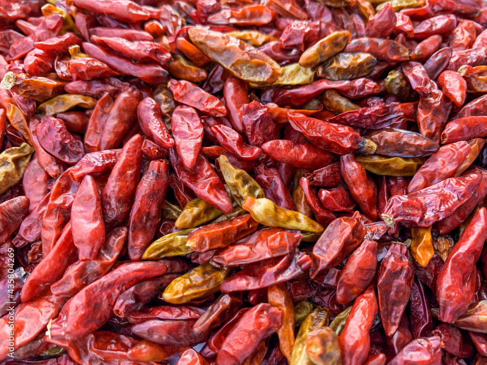 dried red chili peppers in group with close up view.