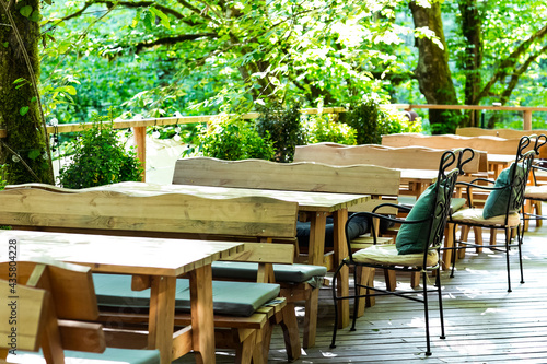 stylish wooden furniture in a summer outdoor cafe