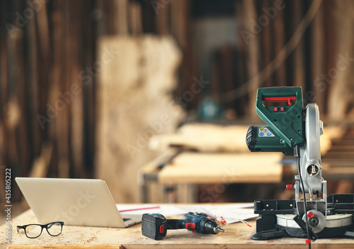 Tableau sur toile Carpenter workplace with laptop and professional equipment