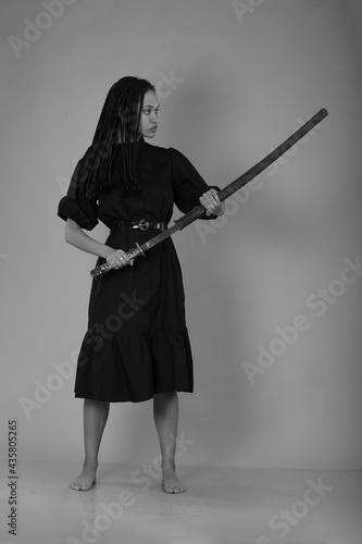 Black and white portrait of beautiful woman with sword