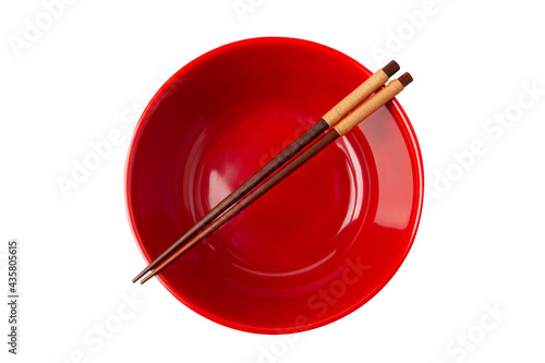 Top view of red empty bowl and chopsticks are placed on top of the bowl isolated on a white background.