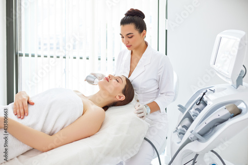 Woman getting SMAS lifting procedure in beauty clinic