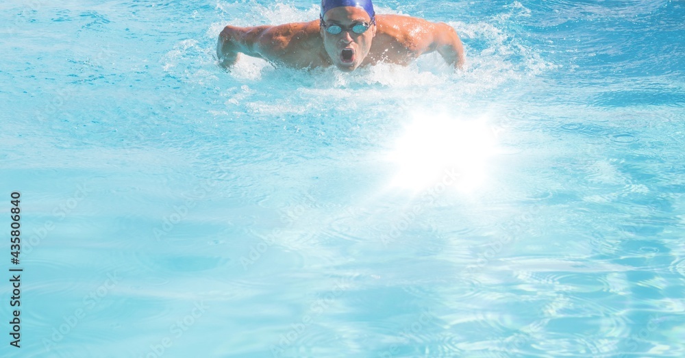 Composition of male swimmer in swimming pool with clear water, glowing light and copy space