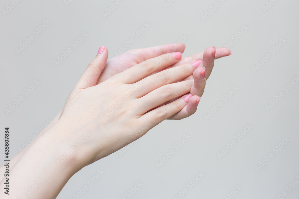Beautiful woman hand, female hand applying lotion or hand cream to hand care in spa and manicure concept.