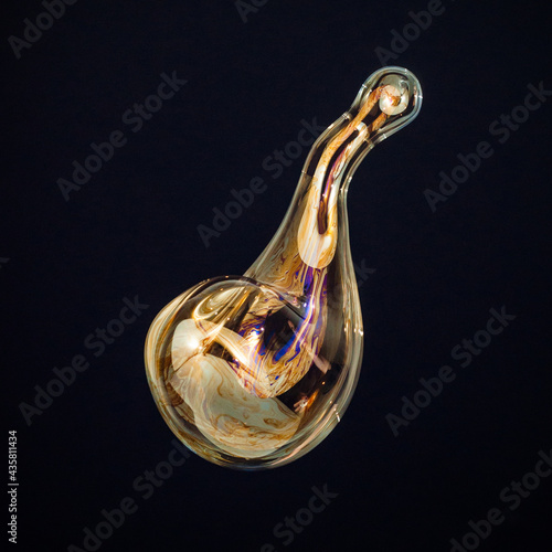 Amorphous and colorful isolated soap bubble with black background.