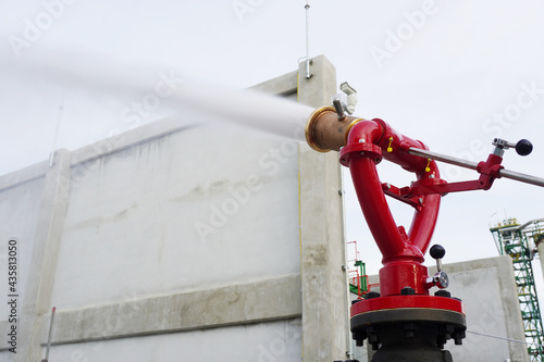 Water flowing vigorously from open fire hydrant as part of the fire extinguishing system testing for safety in the event of an emergency in chemical plants, power plants, oil and gas industry.