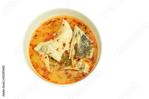 spicy boiled bass fish with herb in tom yum soup on bowl