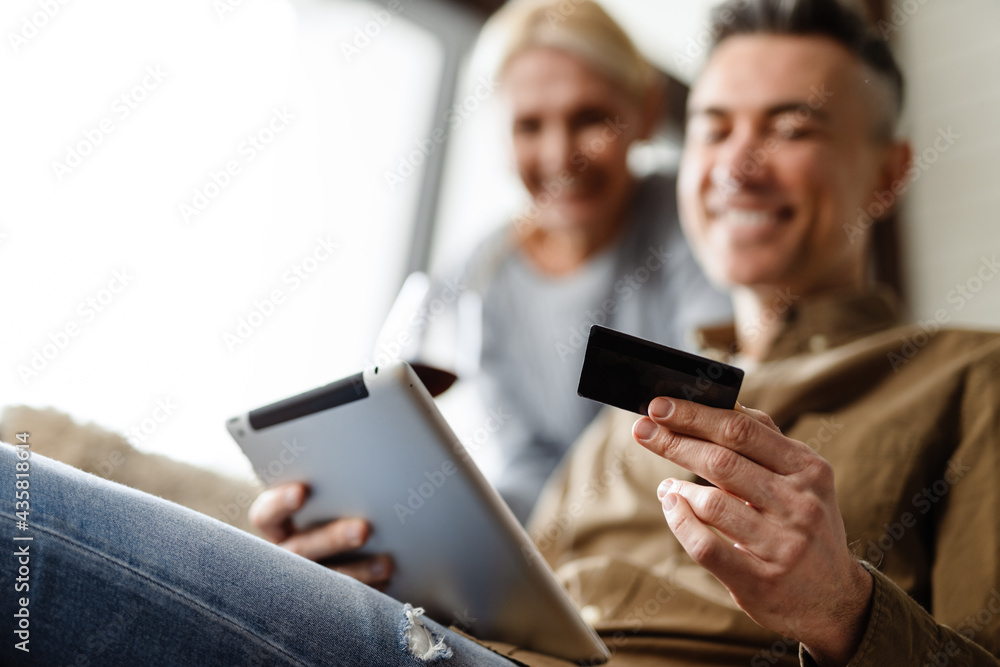 Smiling middle aged white couple relaxing on a couch Smiling middle aged white couple relaxing on a couch