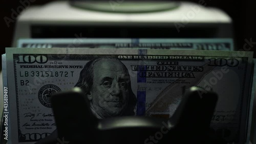 Bill Counting Machine Counting On Hundred Dollar Bills. Money Counting Equipment Financial Operations. Currency Exchange of One Hundred Usd. Counting USA Cash