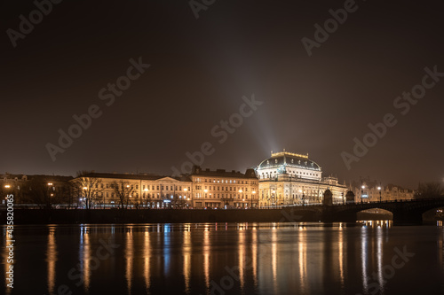 The historic National Theatre in Prague (Národní divadlo) with the sorrounding buildings, shot at night from Strelecky ostrov - long exposure photo