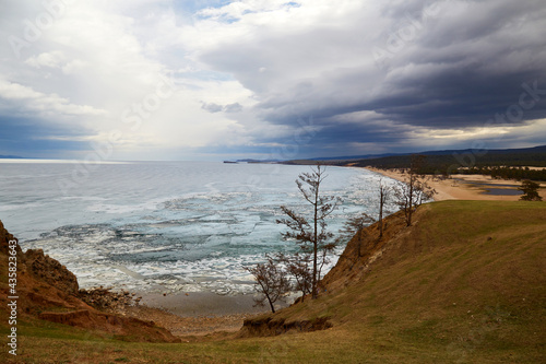 Lake Baikal on a cloudy spring day. Stormy sky  Sarai Bay during the melting of the ice. Olkhon Island.