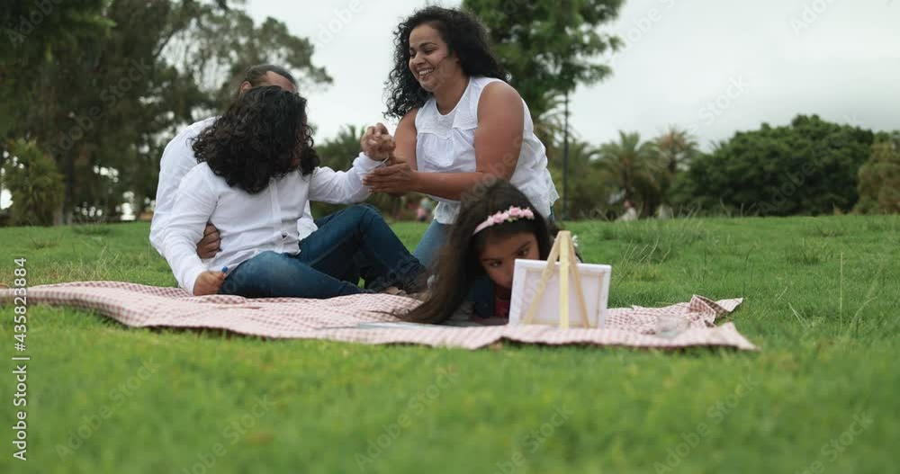 Indian parents having fun at city park playing with their children - Family, summer and love concept Indian parents having fun at city park playing with their children - Family, summer and love concept
