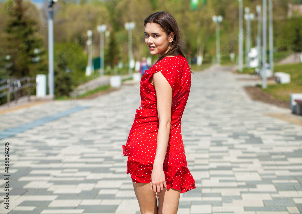 Back view portrait, young slender woman in red dress Back view portrait, young slender woman in red dress