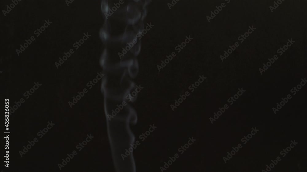 Swirls of white smoke on a black background. Slow motion. The concept of aromatherapy Swirls of white smoke on a black background. Slow motion. The concept of aromatherapy