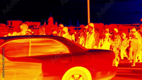 A lot of people are moving across the street in big town. Rush hour, close of business. Videos in red and blue colors. Super slow motion 1000 fps, thermography