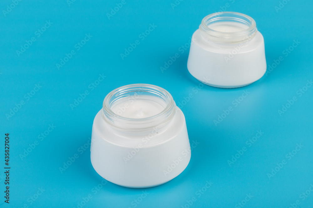 Beauty Cream Texture Close Up. Cosmetic Skincare Product In Jar On Blue Background. High Quality Beauty Cream Texture Close Up. Cosmetic Skincare Product In Jar On Blue Background. High Quality