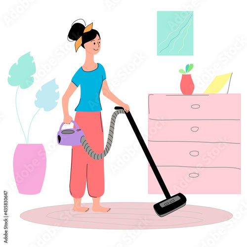 A woman is dusting the floor with a vacuum cleaner in the living room.