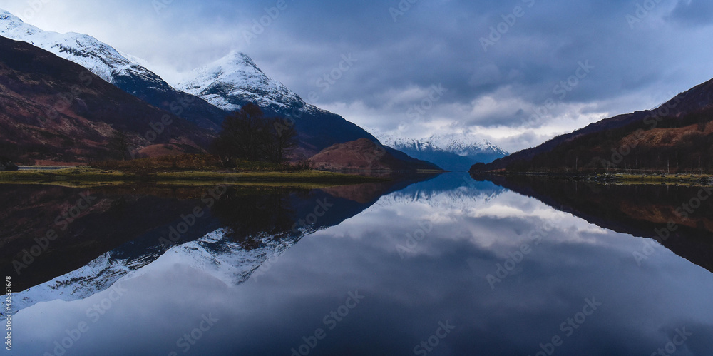 Snow covered Mountains by lake in Glencoe, Scotland