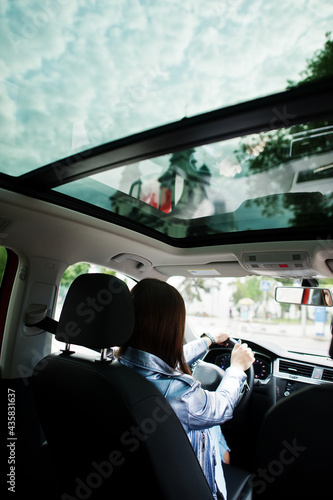 Gorgeous woman sitting inside car interior.