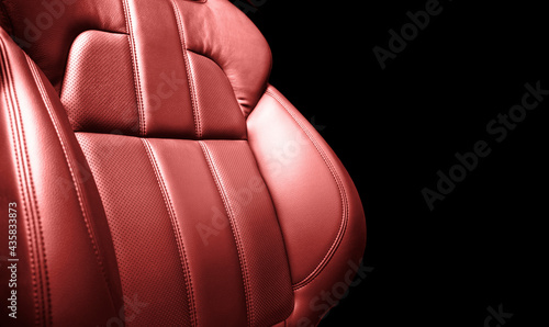 Modern luxury car red leather interior. Part of red perforated leather car seat details with white stitching. Interior of prestige car. Comfortable perforated leather seats. Perforated leather. © Aleksei