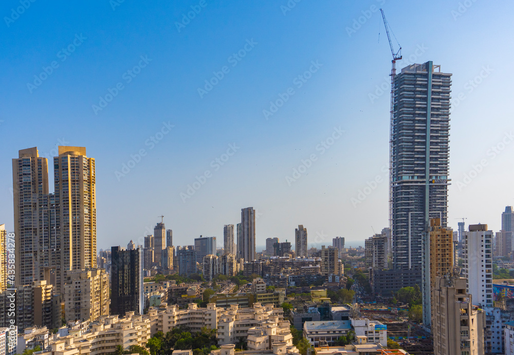 Fototapeta premium Mumbai, Maharashtra - April 5 2021: HDR image of Antilia Building shot against the sky with other city street buildings