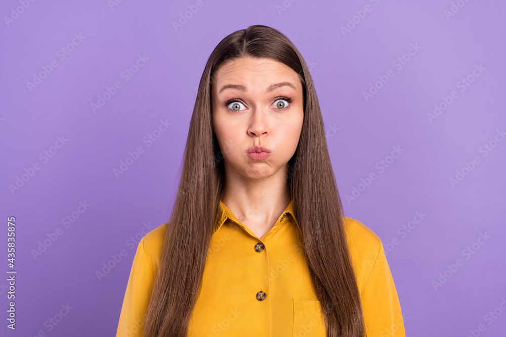 Photo of carefree young lady hold air wear yellow shirt isolated on vivid violet color background Photo of carefree young lady hold air wear yellow shirt isolated on vivid violet color background