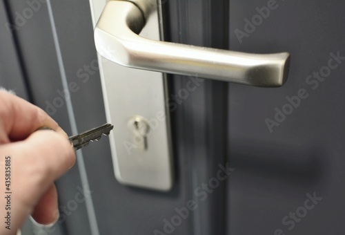 Photography A hand holding a key for inserting a key into the door lock
