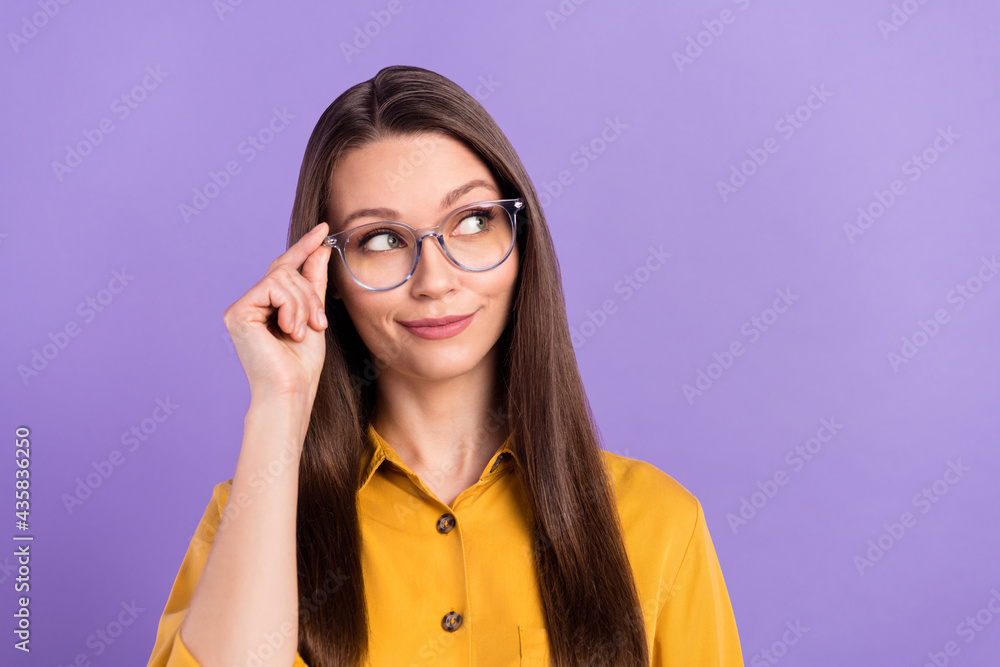 Photo of intelligent lady look empty space touch eyewear wear yellow shirt isolated on violet color background Photo of intelligent lady look empty space touch eyewear wear yellow shirt isolated on violet color background