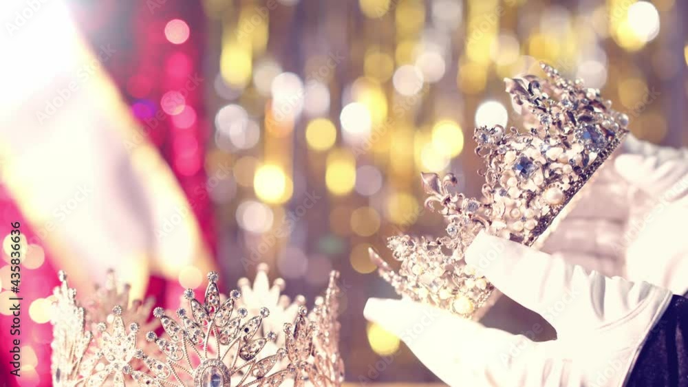 Before the event, a beauty pageant official checks the winner's crown ...