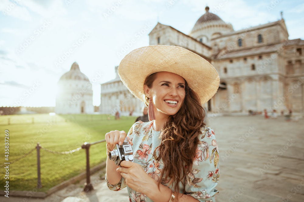 smiling young solo tourist woman in floral dress