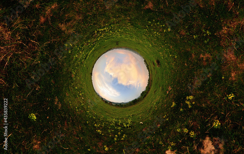 Stereographic panoramic projection of a filed in sunset light. 360 degree panorama.