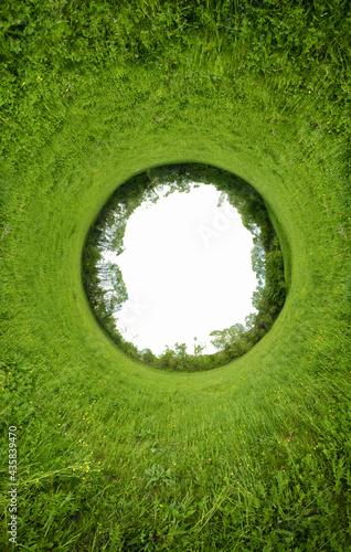 Stereographic panoramic projection of a green field in the summer. 360 degree panorama.