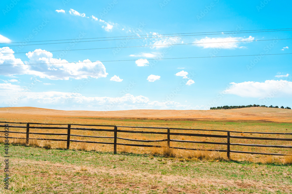 Beautiful rustic landscape with field and wooden fence, natural background