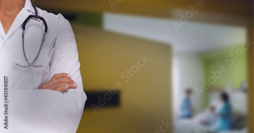 Doctor wearing white blouse and stetoscop with couple having baby photo