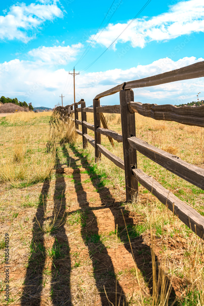Beautiful rustic landscape with field and wooden fence, natural background