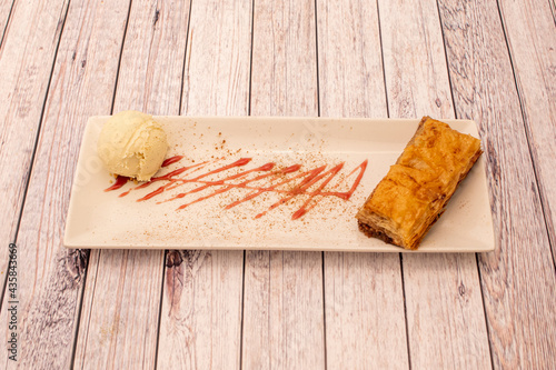 European presentation of baklava with a scoop of vanilla ice cream photo